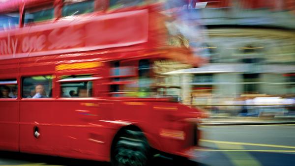 Double decker speeding down the streets of London, England