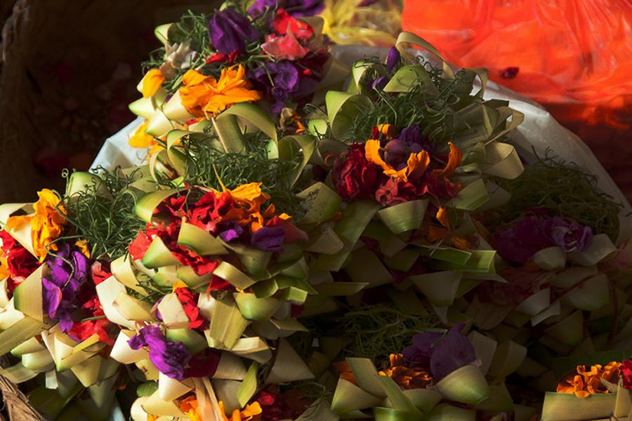 A closer look at the intricate, beautiful baskets of flowers, incense and, sometimes, food