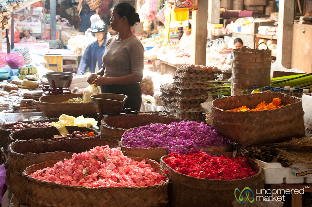 Baskets full of flower petals at the market to be used for canang sari creation.