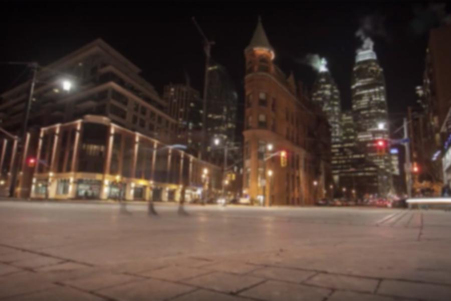 Watch the night come alive with big-time city buzz in the shadows of Toronto's red-brick Gooderham Building.