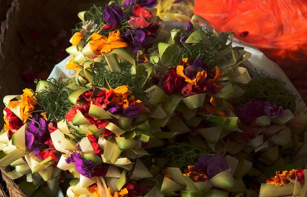 A closer look at the intricate, beautiful baskets of flowers, incense and, sometimes, food